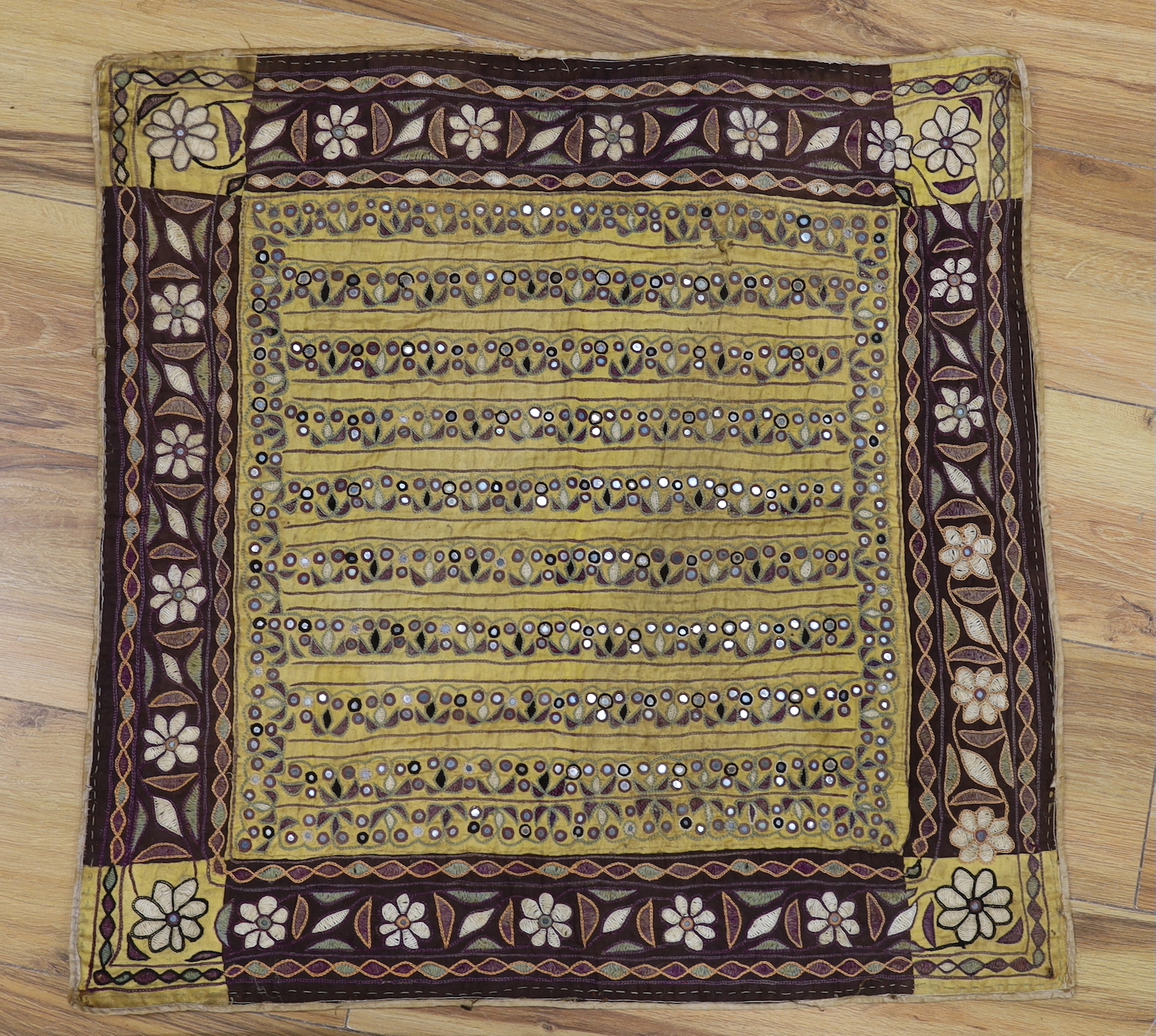 Two Indian embroidered and mirrored panels, possibly wall hangings, the largest 86cm x 67cm